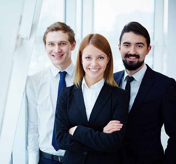 Business team Three successful business partners looking at camera with smiles