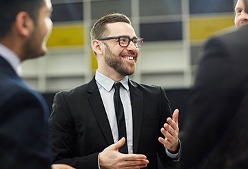 Talk of expert Happy professional talking to his colleagues about new business strategies